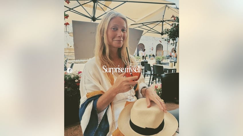 gwyneth paltrow holding a drink