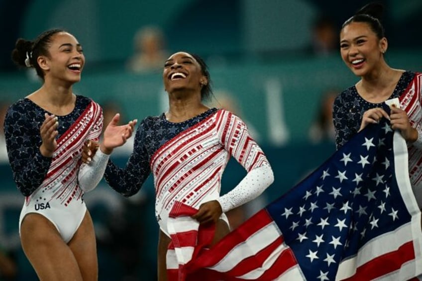 Simone Biles and US teammates celebrate after winning Olympic gold in the women's gymnasti