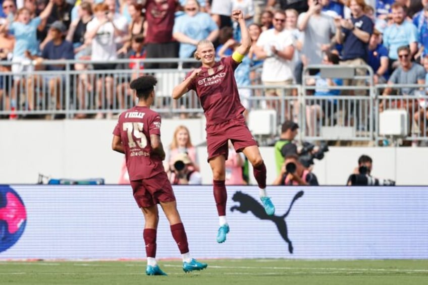 Manchester City forward Erling Haaland, right, celebrates after scoring his second goal ag