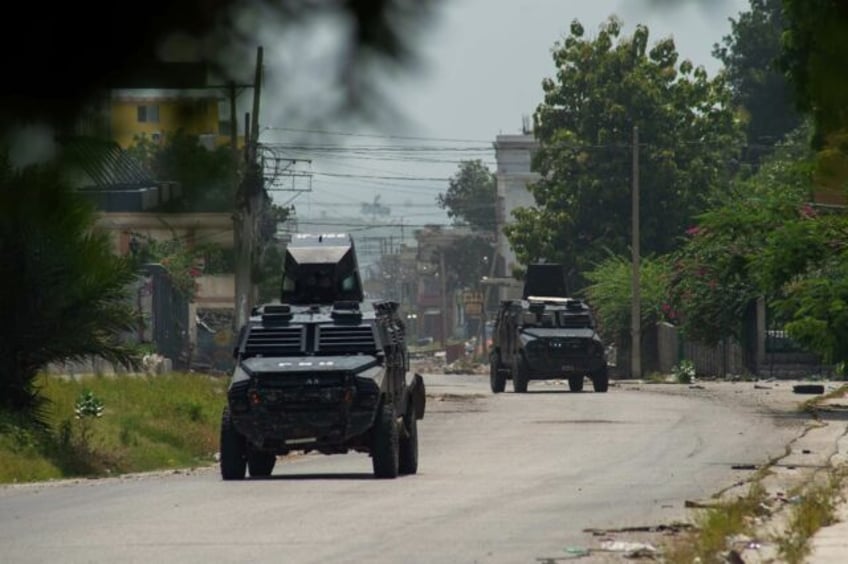 Police tanks patrol the area near the National Palace in Port-au-Prince, Haiti, on June 28