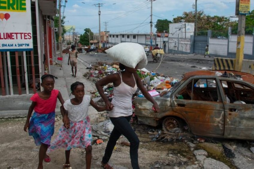 People flee their homes in Haiti's capital after gang attacks, May 2, 2024