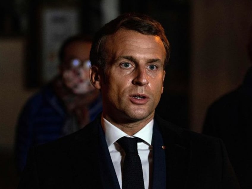 French President Emmanuel Macron speaks on October 16, 2020, in front of a middle school in Conflans Saint-Honorine, 30kms northwest of Paris, after a teacher was decapitated by an attacker who has been shot dead by policemen. - French anti-terror prosecutors said on October 16 they were investigating an assault in which a man was decapitated on the outskirts of Paris and the attacker shot by police. The attack happened at around 5 pm (1500 GMT) near a school in Conflans Saint-Honorine, a western suburb of the French capital. The man who was decapitated was a history teacher who had recently shown caricatures of the Prophet Mohammed in class. French prosecutors are treating the attack as a terror incident, which coincides with the trial of alleged accomplices of the 2015 Charlie Hebdo attackers and comes weeks after a man injured two people he thought worked for the magazine. (Photo by ABDULMONAM EASSA / POOL / AFP) (Photo by ABDULMONAM EASSA/POOL/AFP via Getty Images)