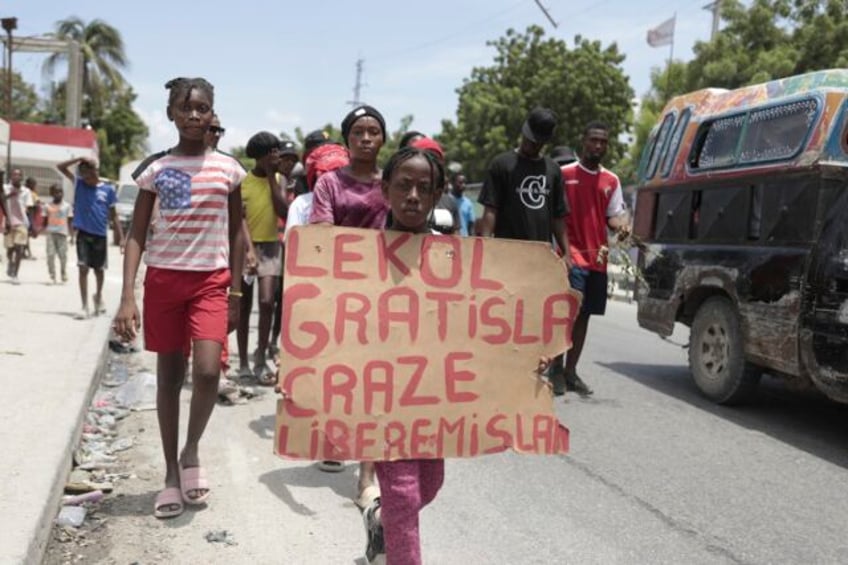 haitians weary of gang violence protest the kidnapping of an american nurse and her daughter