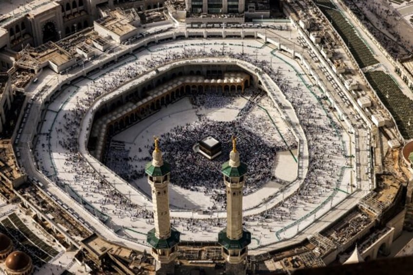Muslim worshippers gather around the Kaaba, Islam's holiest shrine, at the Grand Mosque co