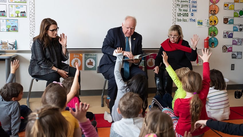 Minesota Gov. Tim Walz, along with Lt. Gov. Peggy Flanagan and first lady Gwen Walz, read to students