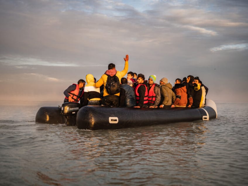 TOPSHOT - Migrants sail after boarding a smuggler's boat on the beach of Gravelines, near Dunkirk, northern France on October 12, 2022, in an attempt to cross the English Channel. Since the beginning of the year, more than 33,500 people have already made the perilous crossing of the English Channel, …