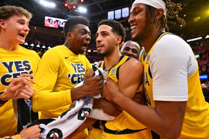 Tyrese Haliburton is mobbed by his Indiana team-mates after his winning three-pointer put