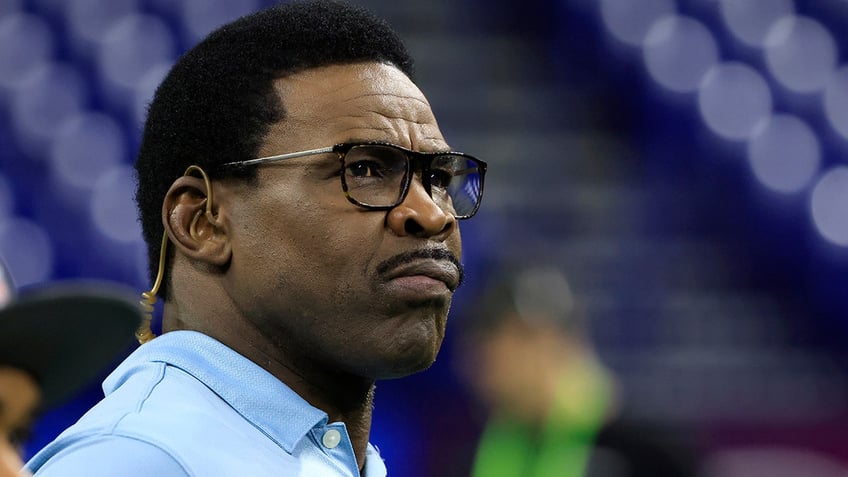 Michael Irvin looks on field