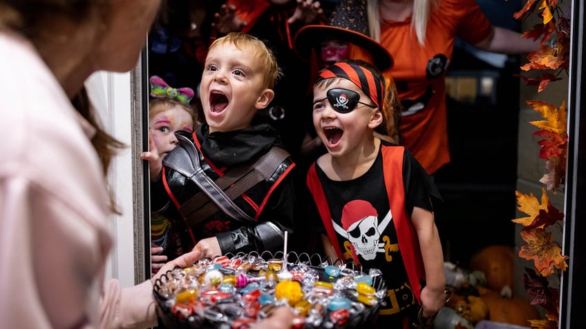 A small group of children shouting trick or treat