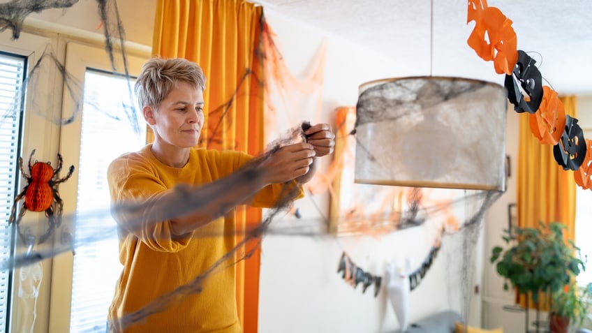 woman decorating for halloween