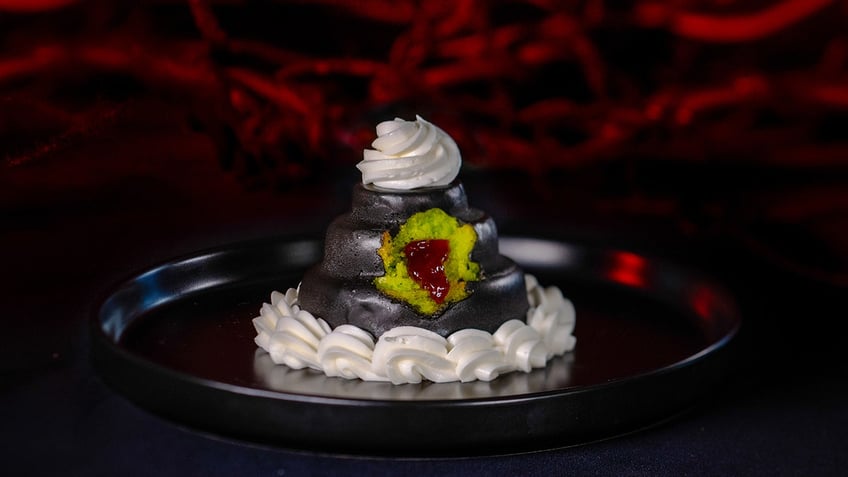 A tiny wedding cake with green cake and chocolate.