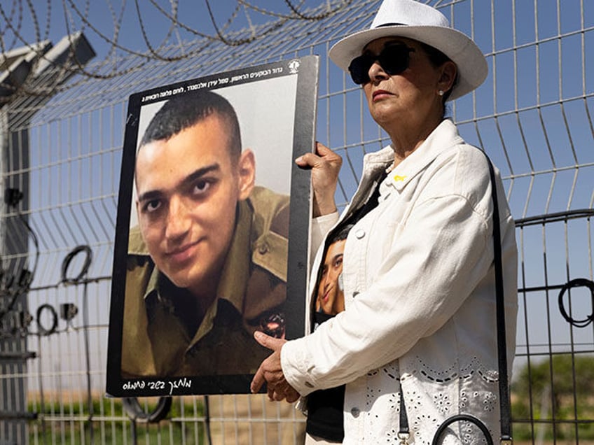 Varda Ben Baruch holds a photo of her grandson Israeli- American hostage Edan Alexander du