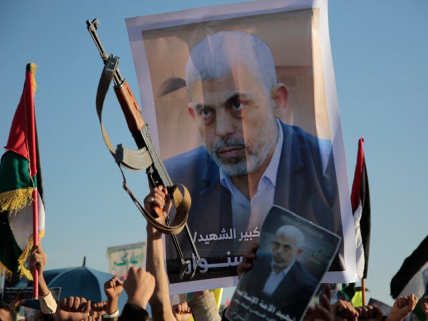 Houthi supporters raise a poster of Hamas leader Yahya Sinwar, who killed by Israeli troop