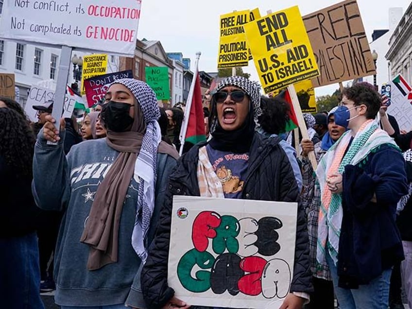 Protesters gather in the Georgetown neighborhood of Washington, Friday, Nov. 24, 2023, in