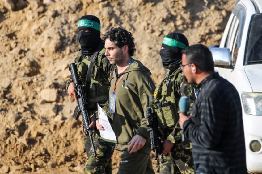 Palestinian militant group Hamas fighters escort French-Israeli hostage Ofer Kalderon befo