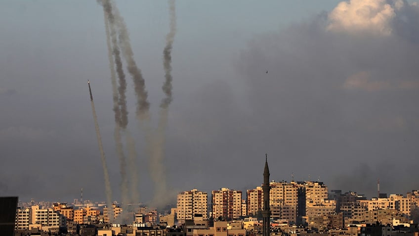 hamas launches massive rocket barrage as israel delays invasion