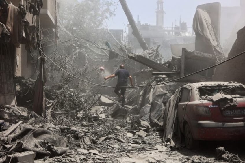 A Palestinian man inspects the rubble following Israeli strikes on a home in Tuffah neighb