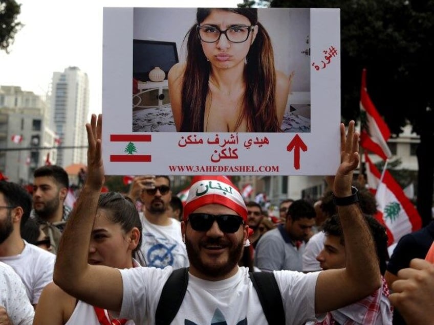 A Lebanese man holds a picture of Lebanese porn actress Mia Khalifa as he takes part in a