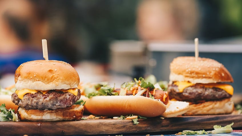 hamburgers and hot dogs on table