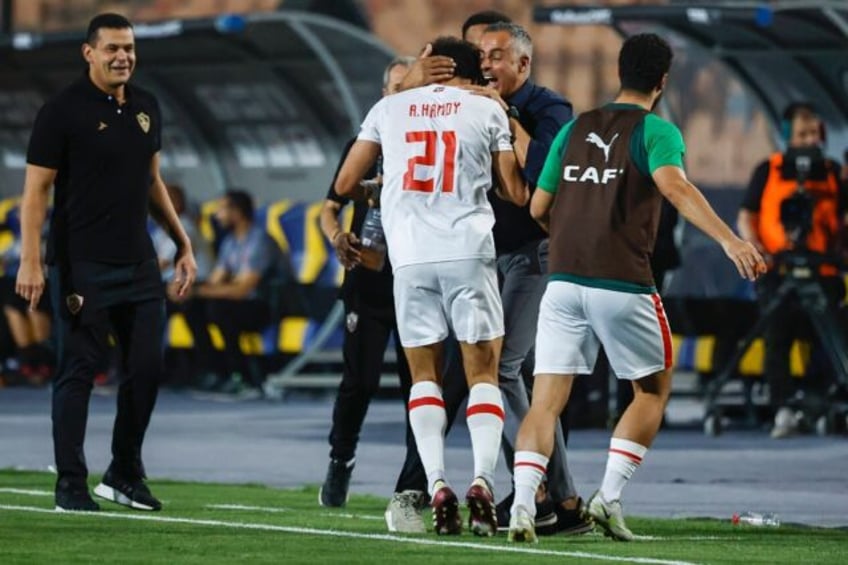 Championship winner: Ahmed Hamdy (C) celebrates with Zamalek coach Jose Gomes (2R)