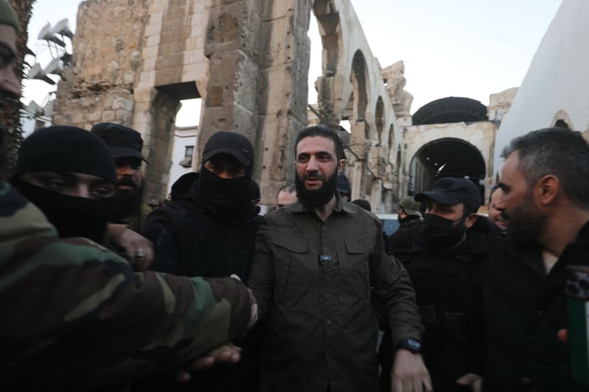 handshake of shame macron welcomes islamist al qaeda linked president of syria to paris