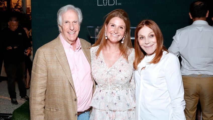 Henry Winkler and his wife smile with their daughter