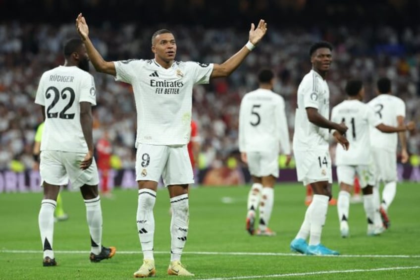 Real Madrid forward Kylian Mbappe celebrates after scoring his team's first goal against S