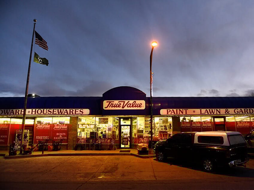 RANGELY, CO - DECEMBER 5 - The sun sets above the brightly lit True Value hardware store o