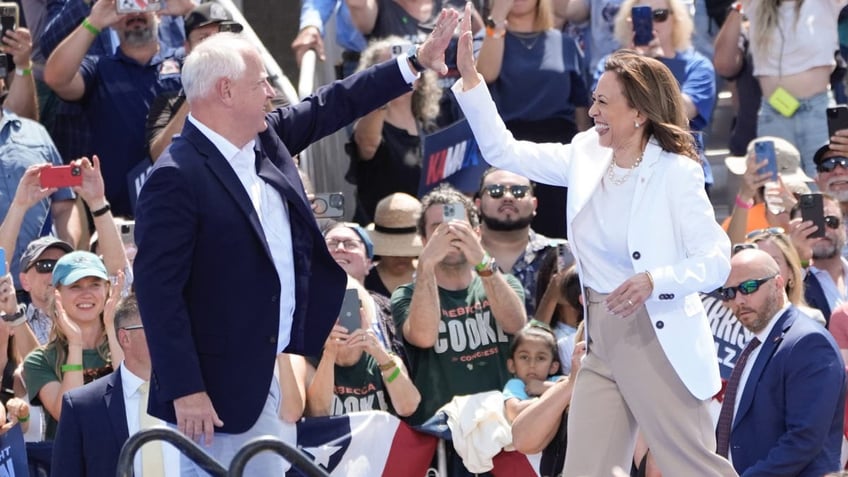 Tim Walz and Kamala Harris at rally high-fiving