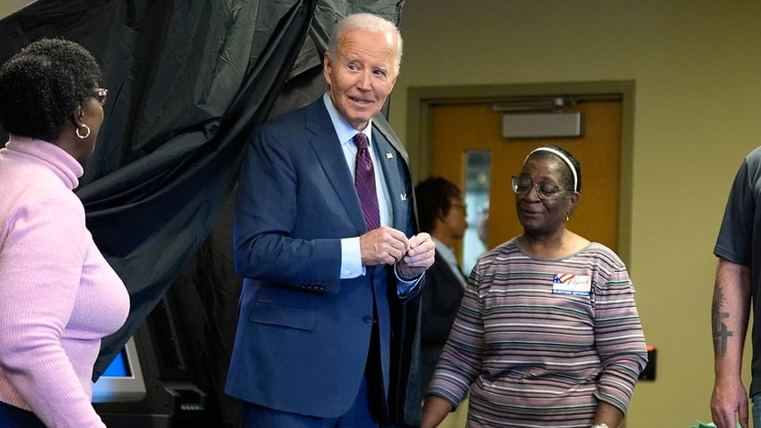 Biden leaving voting booth