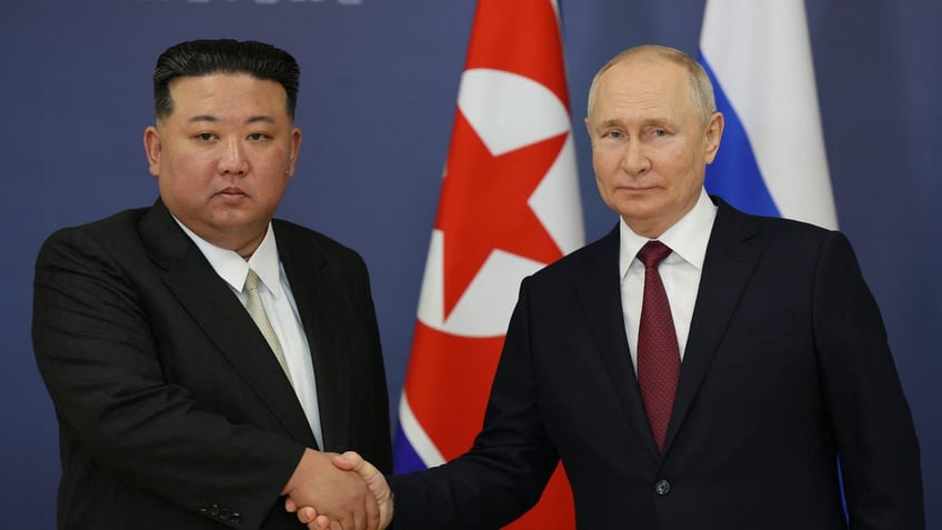 Putin and Kim shake hands