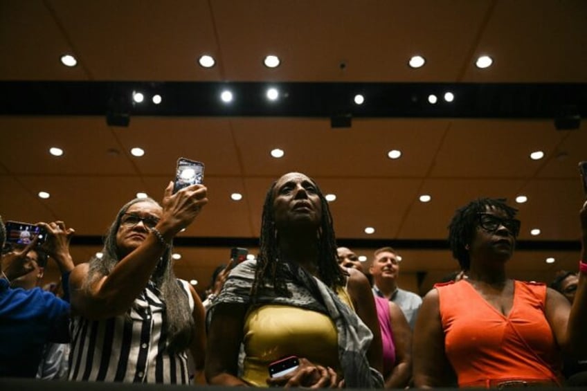 Attendees listen to US President Joe Biden and Vice President Kamala Harris speak in the o