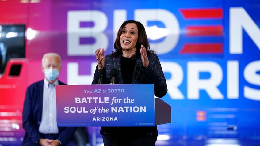 Then-Democratic presidential candidate former Vice President Joe Biden listens as then-Democratic vice presidential candidate Sen. Kamala Harris, D-Calif., speak at the Carpenters Local Union 1912 in Phoenix, Thursday, Oct. 8, 2020, to kick off a small business bus tour. (AP Photo/Carolyn Kaster)