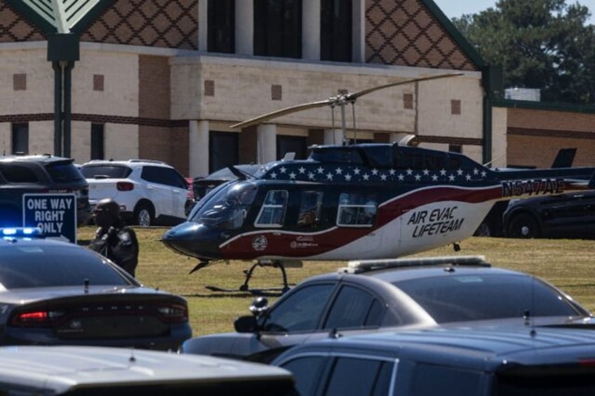 An air evacuation helicopter lands at Apalachee High School in Winder, Georgia, where a sh