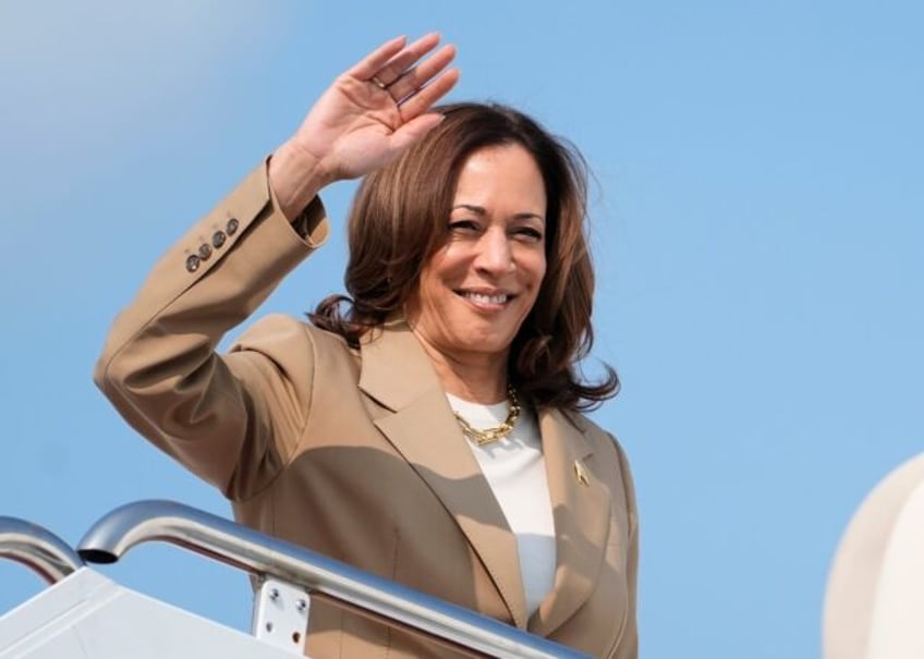 US Vice President and Democratic presidential candidate Kamala Harris waves while boarding