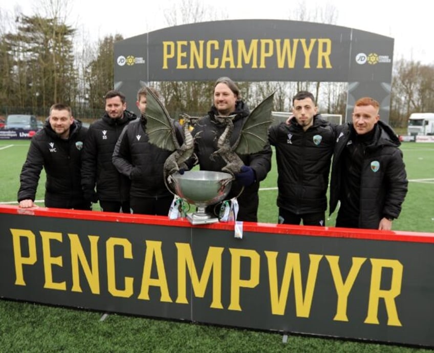 New Saints coach Craig Harrison shows off the Welsh Premier League trophy - now they are s