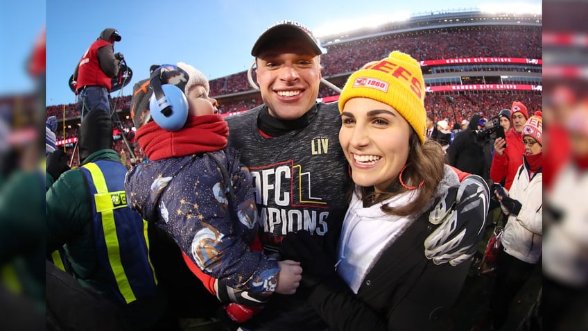 Harrison Butker holds his child alongside wife Isabelle Butker