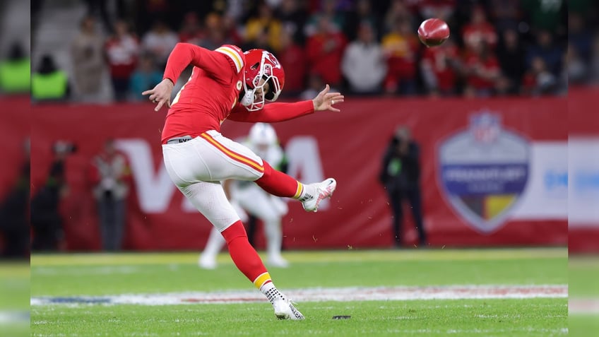 Harrison Butker kicks ball during NFL match