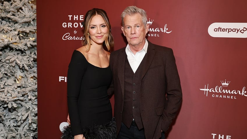 Katherine McPhee and David Foster posing on the red carpet