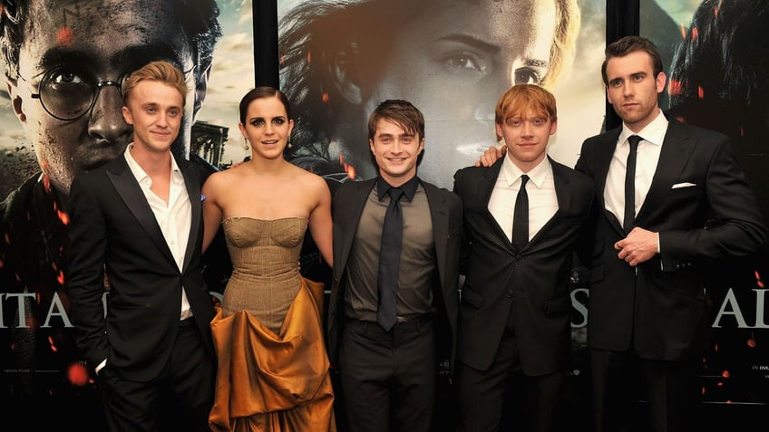 L to R: Tom Felton, Emma Watson, Daniel Radcliffe, Rupert Grint, and Matthew Lewis pose together for the premiere of Harry Potter and the Deathly Hallows Part 2