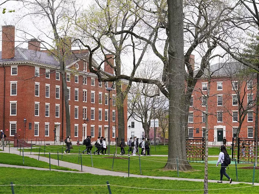 FILE - Students walk through Harvard Yard, April 27, 2022, on the campus of Harvard University in Cambridge, Mass. On Monday, July 24, 2023, the U.S. Department of Education opened an investigation into Harvard University's policies on legacy admissions, which give an edge to applicants with family ties to alumni. …