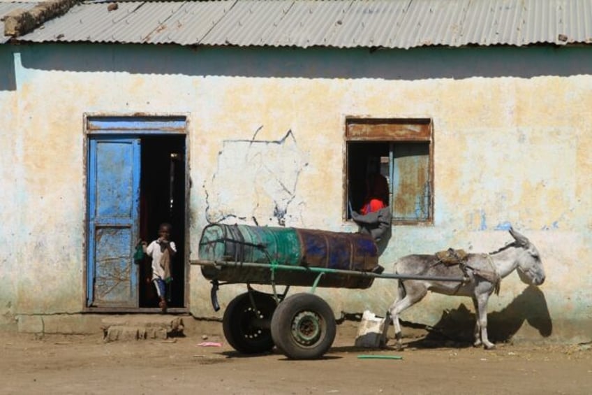 A child displaced from Al-Jazira state at the entrance of a temporary shelter in Gedaref in Sudan's east