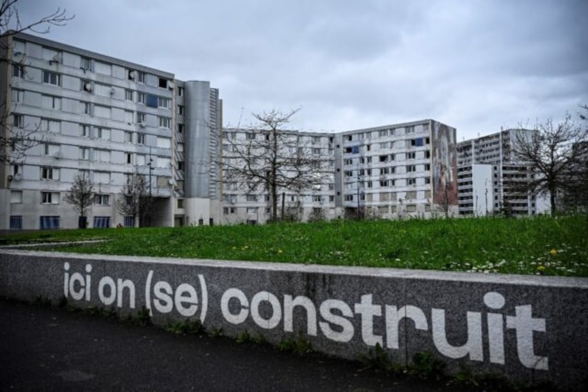 The Francs-Moisins estate near the Stade de France where a sign says 'Here we build (ourse
