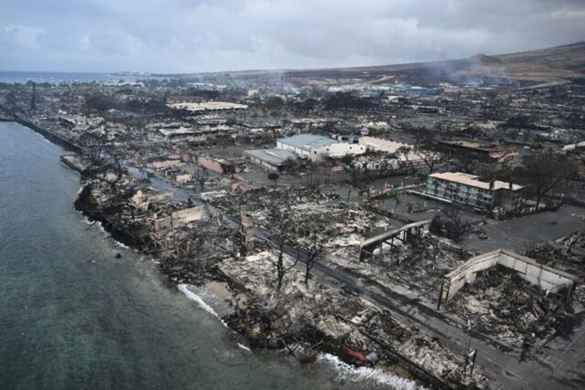 An aerial image shows Old Lahaina Center and Foodland Lahaina standing amongst destroyed h