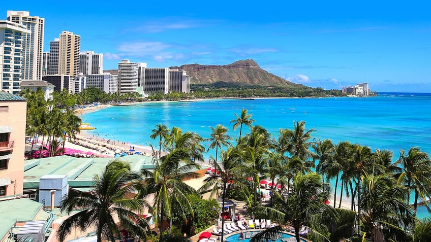 Waikiki Beach Honolulu Hawaii Skyline. The Honolulu Police Department has suggested beachgoers bring their belongings into the water with them amid rising crime in the area.