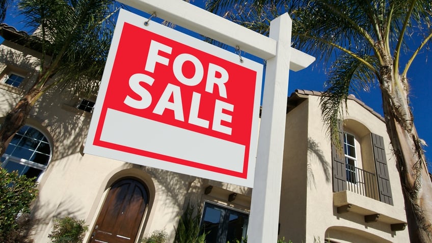 home for sale with sign in front