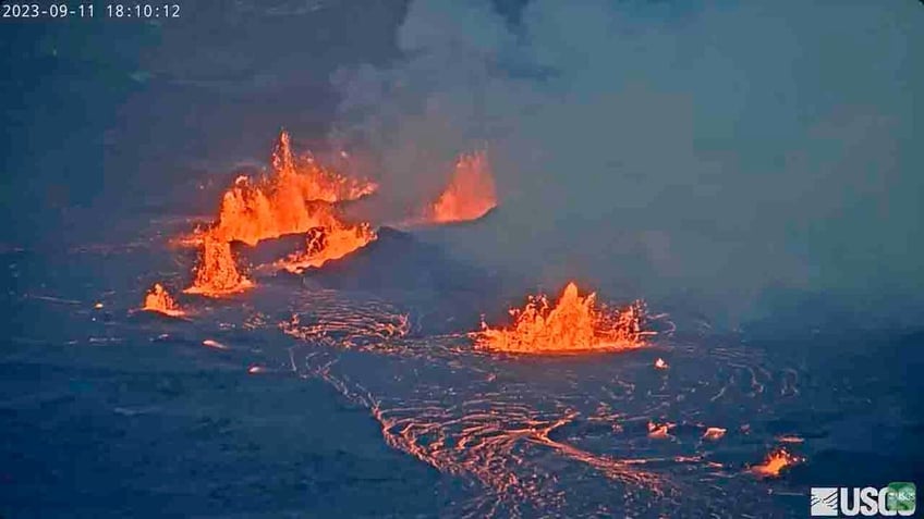 hawaiis kilauea volcano spews lava fountains as lake of molten rock lights up night video shows