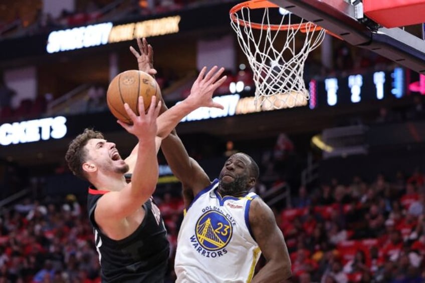 Alperen Sengun of the Houston Rockets shoots against Draymond Green in the Rockets' NBA Cu