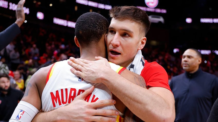 Bogdan Bogdanovic hugs teammate after Hawks game