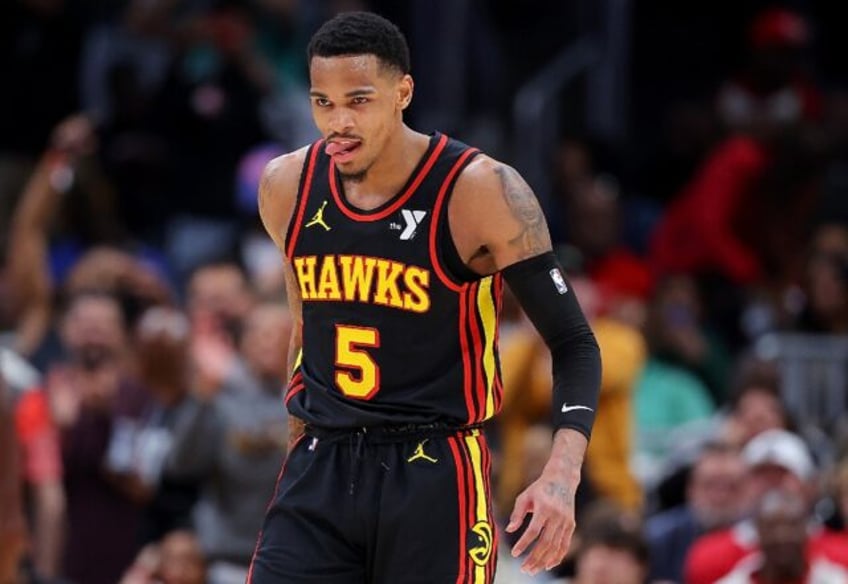 Atlanta's Dejounte Murray reacts after hitting a three-point basket in the Hawks' NBA over